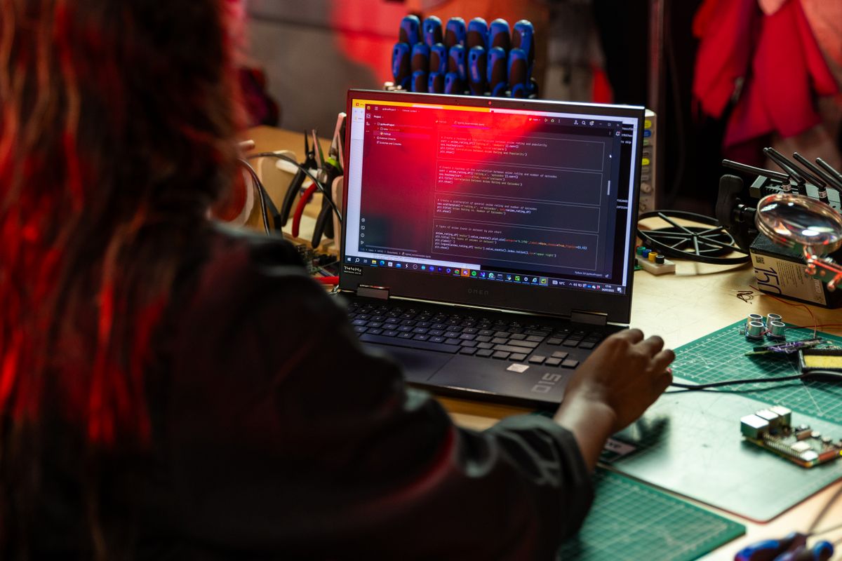 Software developer working with code and electronics
