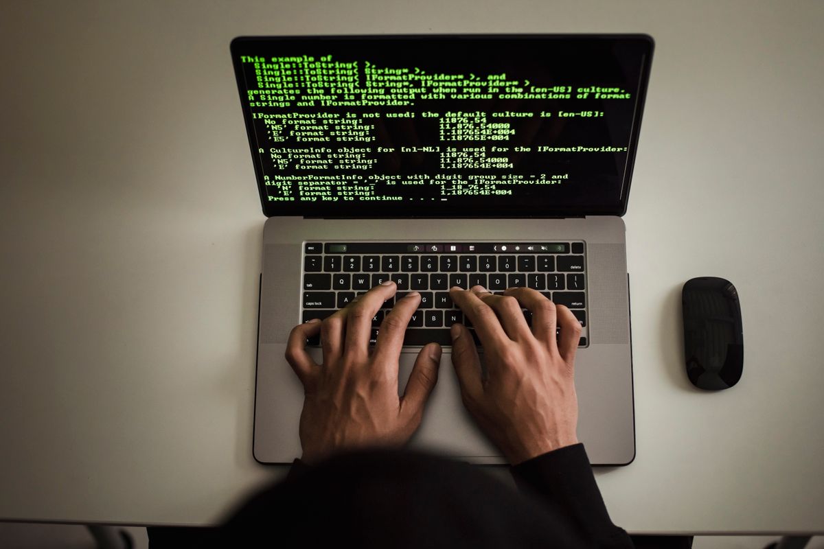 Developer working on source code at a laptop